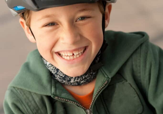 Boy wearing bike helmet outdoors